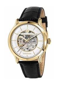 Automatisch horloge met een goudkleurige roestvrijstalen kast, witte wijzerplaat, helder skeletontwerp, zwarte leren band en een reliëfstructuur.