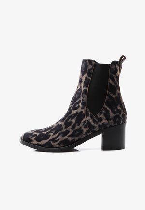 Botines con estampado de leopardo en tejido suave, con paneles laterales elásticos negros, punta afilada y tacón grueso negro. Estilo clásico de botines Chelsea.