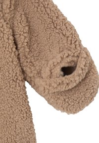 Tan fleece fabric with a textured, fluffy surface. The garment features a wide, round sleeve opening for comfort and ease of wear.