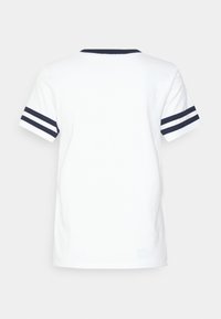 White T-shirt with a navy crew neckline and short sleeves. Features navy and white striped accents on the sleeves. Plain back design.