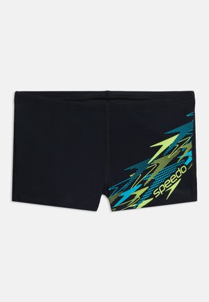 Čierne plavecké krátke nohavice s neonovo modrými a žltými cikcak vzormi a logom Speedo na pravej stehnovej oblasti.