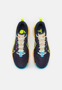 Marineblauwe hardloopschoenen met een bovenwerk van mesh, neongele accenten, lichtblauwe veters en oranje zolen. Inclusief logodetail op de tong.