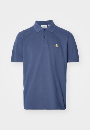 Donkerblauwe polo met korte mouwen, een placket met twee knopen en een klein geel logo op de borst. Gemaakt van een zachte katoenmateriaal.