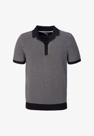 Polo a maniche corte in tessuto a contrasto bianco e nero con colletto nero, patta con bottoni, polsini e fascia in vita neri.