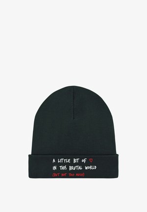 Black knitted beanie with a snug fit. Features white and red text on the folded cuff, reading a playful phrase about the world.