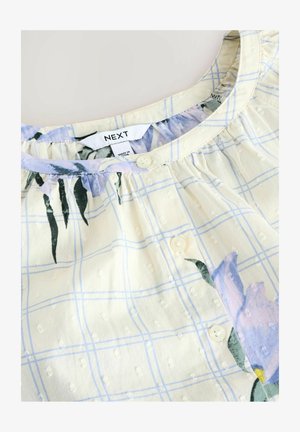 Camicia a bottoni realizzata in un tessuto leggero, caratterizzata da un motivo a quadri giallo e blu, con accenti floreali e una finitura testurizzata.