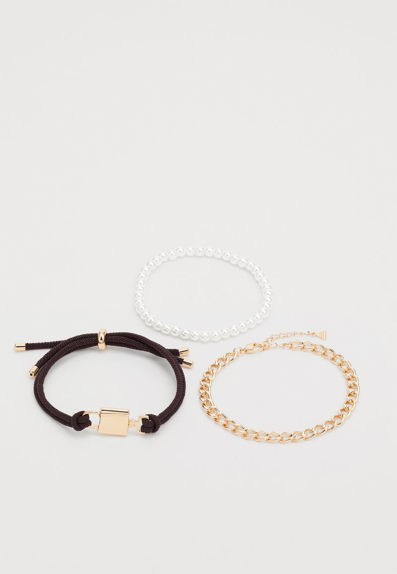 Three bracelets: one with brown rope and gold hardware, a clear beaded one, and a gold chain link bracelet.