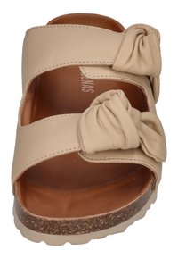 Beige leather slide sandal with two knotted straps, open toe design, and a textured cork sole. Smooth inner lining provides comfort.