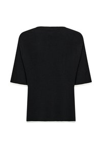 Svart kortärmad stickad topp med vita kanter på ärmar och nederkant, med ribbad textur och en enkel rund halsringning.