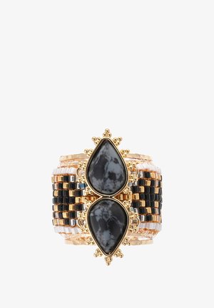Gold-tone bracelet with two teardrop-shaped black stones at the center, surrounded by beaded rows in black, gold, and clear colors.