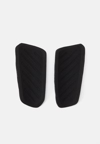Crni gumenjaci ulošci za cipele s teksturiranim dijagonalnim utorima, označeni lijevo i desno. Blago zakrivljen oblik za pristanak na stopalo.
