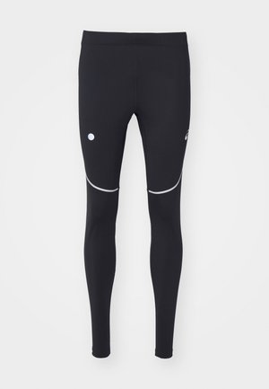 Leggings de sport noirs en tissu extensible, avec des accents réfléchissants et un logo circulaire sur la cuisse gauche. Design ajusté.