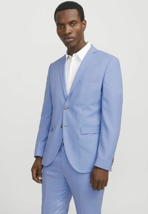 Light blue suit with notch lapels and two buttons, featuring a single chest pocket and matching trousers, worn over a white shirt.