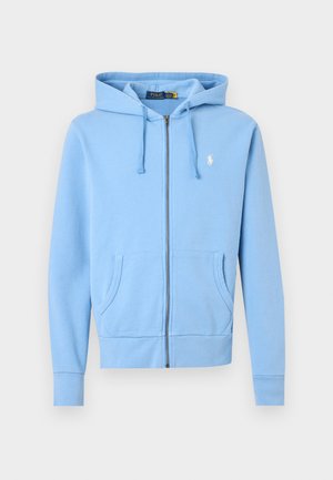 Sweat à capuche bleu clair zippé avec poches avant, cordons de serrage et petit logo Polo Ralph Lauren blanc sur la poitrine gauche.