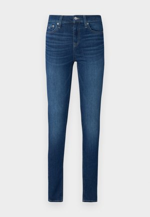 Skinny jeans in dark blue denim, featuring a classic five-pocket design, belt loops, and a front button closure with a zip fly.
