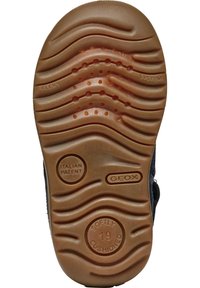 La suola della scarpa presenta un motivo testurizzato e ondulato in gomma beige, con impressioni circolari che recitano "MORBIDAMENTE IMBOTTITO" e "BREVETTO ITALIANO."