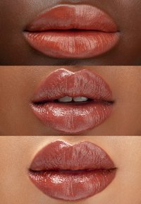 Three close-up images of lips featuring a nude brown lip color. The texture is smooth and glossy, showcasing well-defined lip contours.