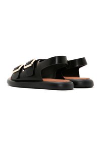 Black leather sandals featuring two adjustable straps with square metallic buckles, open back, and flat rubber soles with a tan insole.