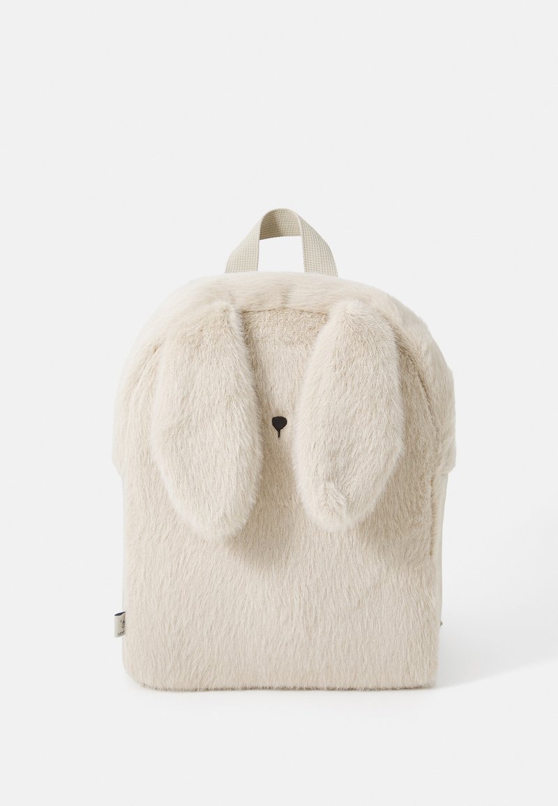 Furry cream backpack with bunny ears, rounded shape, small nose detail, and a top handle. Soft texture and playful design.