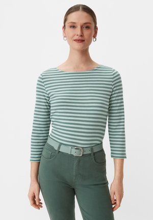 Green striped long-sleeve top with a boat neckline, paired with green belt and pants, featuring a smooth texture and fitted design.