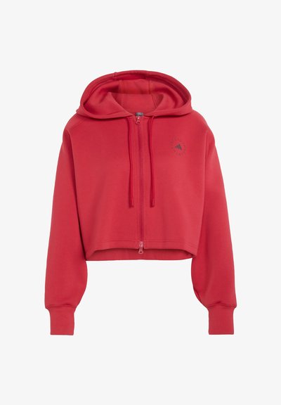 Roter Crop-Hoodie mit langen Ärmeln, einem Frontreißverschluss, Kordelzügen und einem kleinen runden Logo auf der linken Brust.
