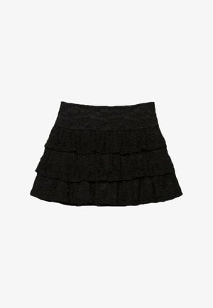 Čierna sukňa s viacerými vrstvami ruflí s textúrovaným kvetinovým vzorom. Elastický pás pre komfort a prispôsobenie.