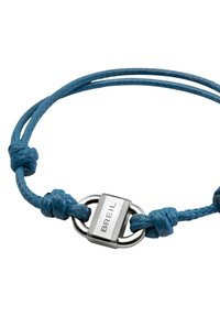 Pulsera de cordón trenzado azul con herrajes de plata con grabado "BREIL" y nudos decorativos. El diseño es simple y funcional.