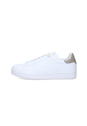 Sneaker bianca low-top con chiusura a lacci, logo laterale in rilievo e linguetta beige con motivo sul tallone, inclinata a sinistra su sfondo bianco.