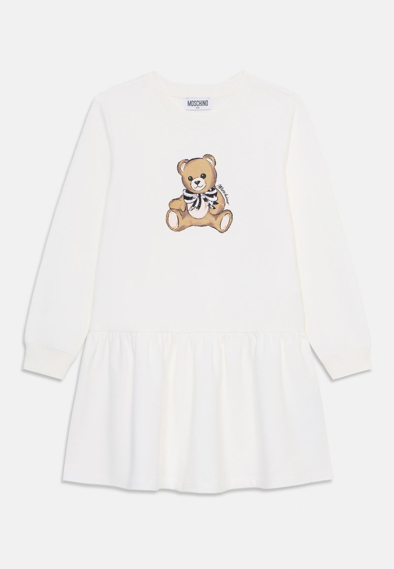 Robe blanche à manches longues avec une jupe froncée. Présente un motif d'ours en peluche sur la poitrine, mettant en avant des tons bruns et des accents en noir et blanc.