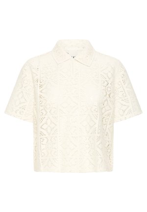 Blouse courte en dentelle crème à manches courtes avec col, présentant des motifs géométriques et floraux découpés ainsi qu'une patte de boutonnage dissimulée à l'avant.