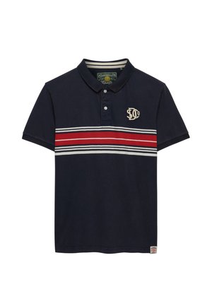 Polo azul marino con cuello, tapeta de dos botones, rayas horizontales rojas y blancas en el pecho y logotipo bordado en el lado izquierdo.