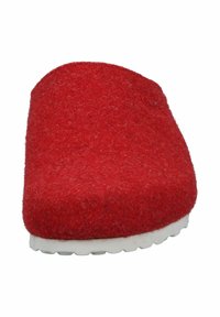 Red felt slipper with a rounded toe, soft texture, and white rubber sole featuring small treads for grip. Simple design, no hardware.