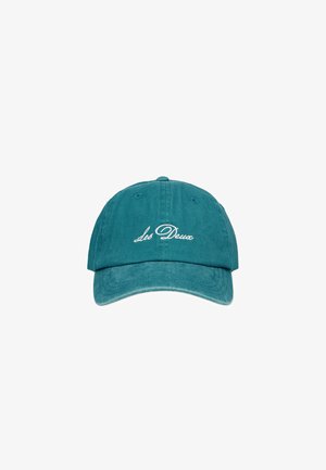 Teal cotton baseball cap with curved brim, featuring white embroidered text "Les Deux" on the front. Soft, textured fabric.