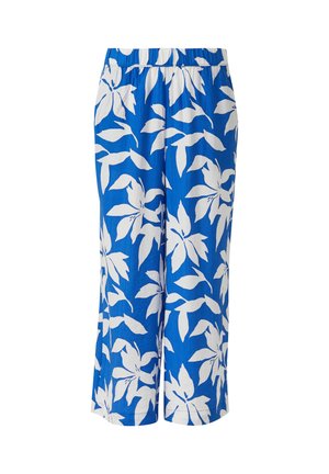 Pantalon bleu à jambes larges avec taille élastique, présentant un grand motif floral blanc en forme de feuilles.
