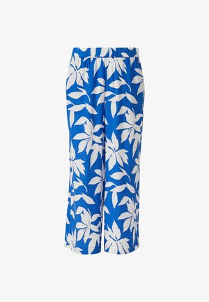 Pantalon bleu à jambes larges avec taille élastique, présentant un grand motif floral blanc en forme de feuilles.
