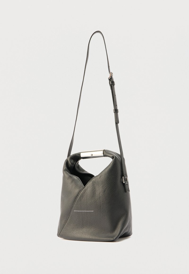 Black leather shoulder bag with a unique folded design, silver hardware, and a long adjustable strap. Features a subtle white stitch detail.