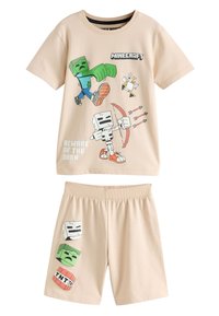 Ensemble de vêtements d'intérieur pour enfants sur le thème de Minecraft, de couleur beige clair. Chemise à manches courtes ornée de graphismes colorés de personnages ; shorts à taille élastique avec motifs imprimés.