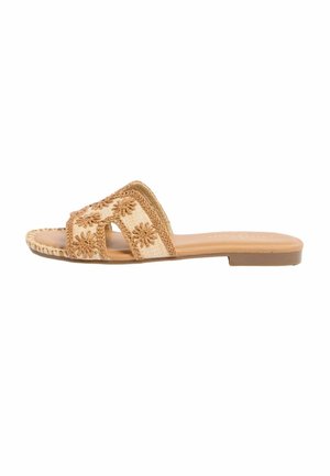 Flat tan slide sandal with open toe, woven fabric strap featuring embroidered floral patterns, and a smooth sole.