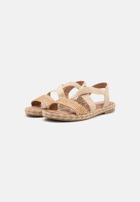 Beige espadrille sandals with woven accents and crisscross straps, featuring a rope sole and smooth leather insole.