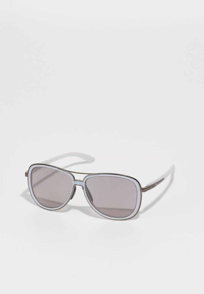 Sunglasses with a silver metal frame, gray lenses, and white plastic tips. Rectangular shape with smooth texture and subtle design details.