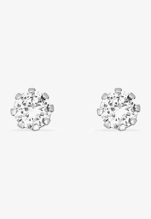 Orecchini a bottone rotondo con pietre in zirconia cubica trasparente, montate a griffes, realizzati in metallo di colore argento. Ogni pietra è sfaccettata, aumentando la brillantezza.