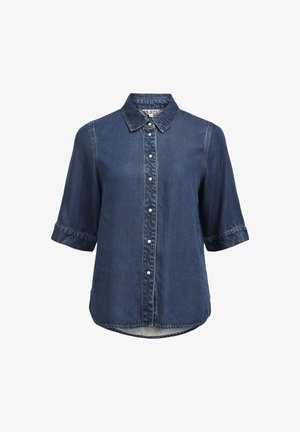 Jeansskjorta med kort ärm, knäppning fram med pärltryckta knappar och lätt rundad nederkant.