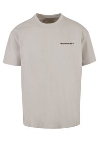Lyse beige T-shirt med korte ærmer og rund hals, prydet med lille sort "MJGONZALES™" tekst på venstre bryst.