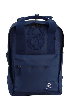 Navy blue backpack made of durable fabric, featuring a front zip pocket, textured handles, and a circular logo on the front.