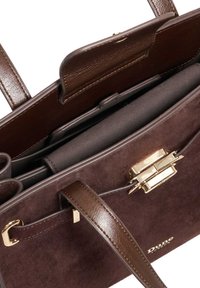 Brown suede handbag with leather accents, gold hardware, and a structured design. Interior features compartments for organization.