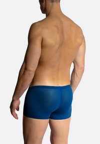 Blue boxer briefs featuring a smooth, stretchy fabric with a snug fit. Simple design with no patterns or visible hardware.