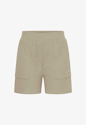 Pantaloncini in maglia beige con texture, dotati di vita elastica e due grandi tasche a toppa frontali, una delle quali con una piccola etichetta del marchio.