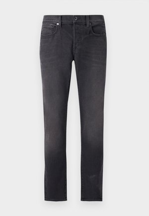 Jeans en denim noir à coupe slim, dotés de cinq poches, d'une fermeture à bouton et d'un léger effet délavé pour un aspect usé.