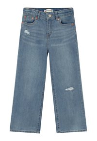 Vaaleansiniset leveälahkeiset farkut, jotka on valmistettu denimistä. Farkuissa on edessä kulunut kohta, metalliosia ja perinteinen viiden taskun malli.