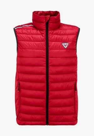 Czerwona kamizelka puchowa z wysokim kołnierzem, pikowanym wzorem, przednim zamkiem błyskawicznym i dwiema bocznymi kieszeniami. Posiada naszywkę z logo na górnej lewej stronie.